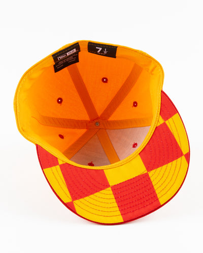 yellow and red New Era fitted cap with Chicago Blackhawks wordmark on front - under brim lay flat