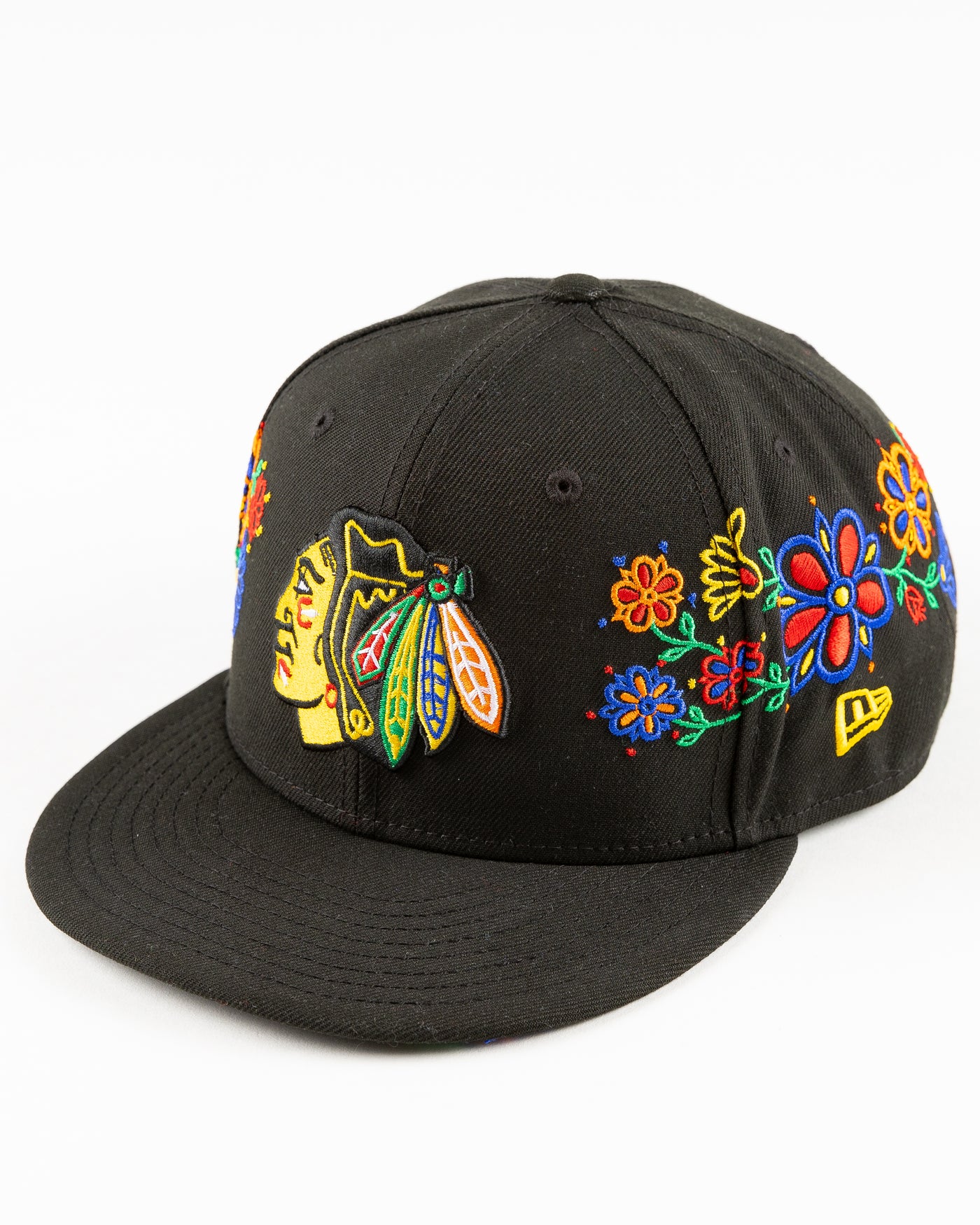 black New Era snapback with Chicago Blackhawks primary logo surrounded by floral pattern - left angle lay flat