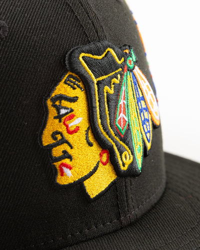 black New Era snapback with Chicago Blackhawks primary logo surrounded by floral pattern - detail lay flat