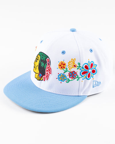 white and blue New Era snapback with vintage Chicago Blackhawks logo and floral pattern on front - left angle lay flat