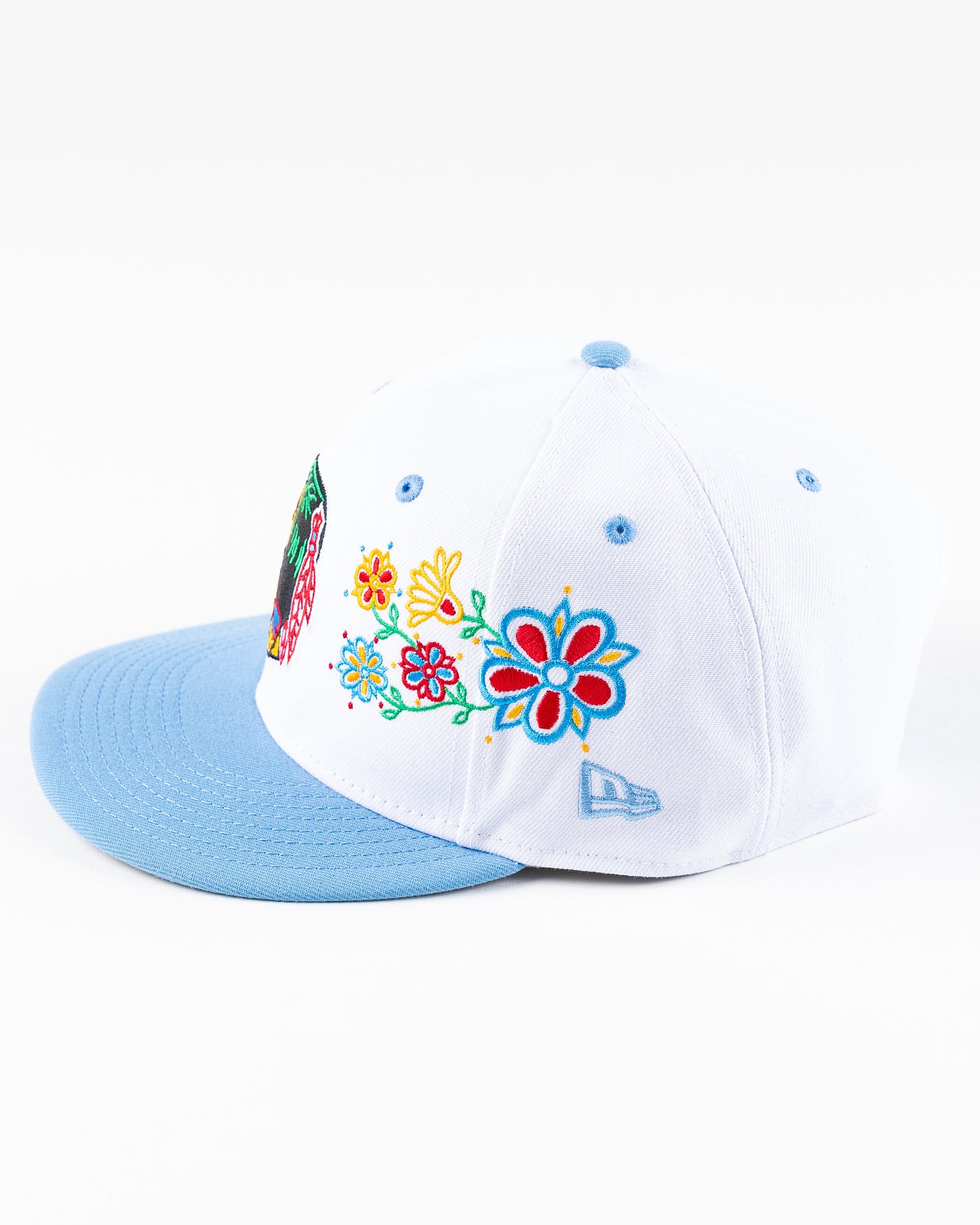white and blue New Era snapback with vintage Chicago Blackhawks logo and floral pattern on front - left side lay flat