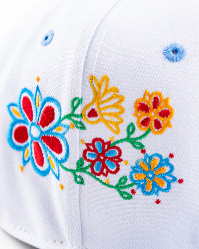 white and blue New Era snapback with vintage Chicago Blackhawks logo and floral pattern on front - detial floral lay flat