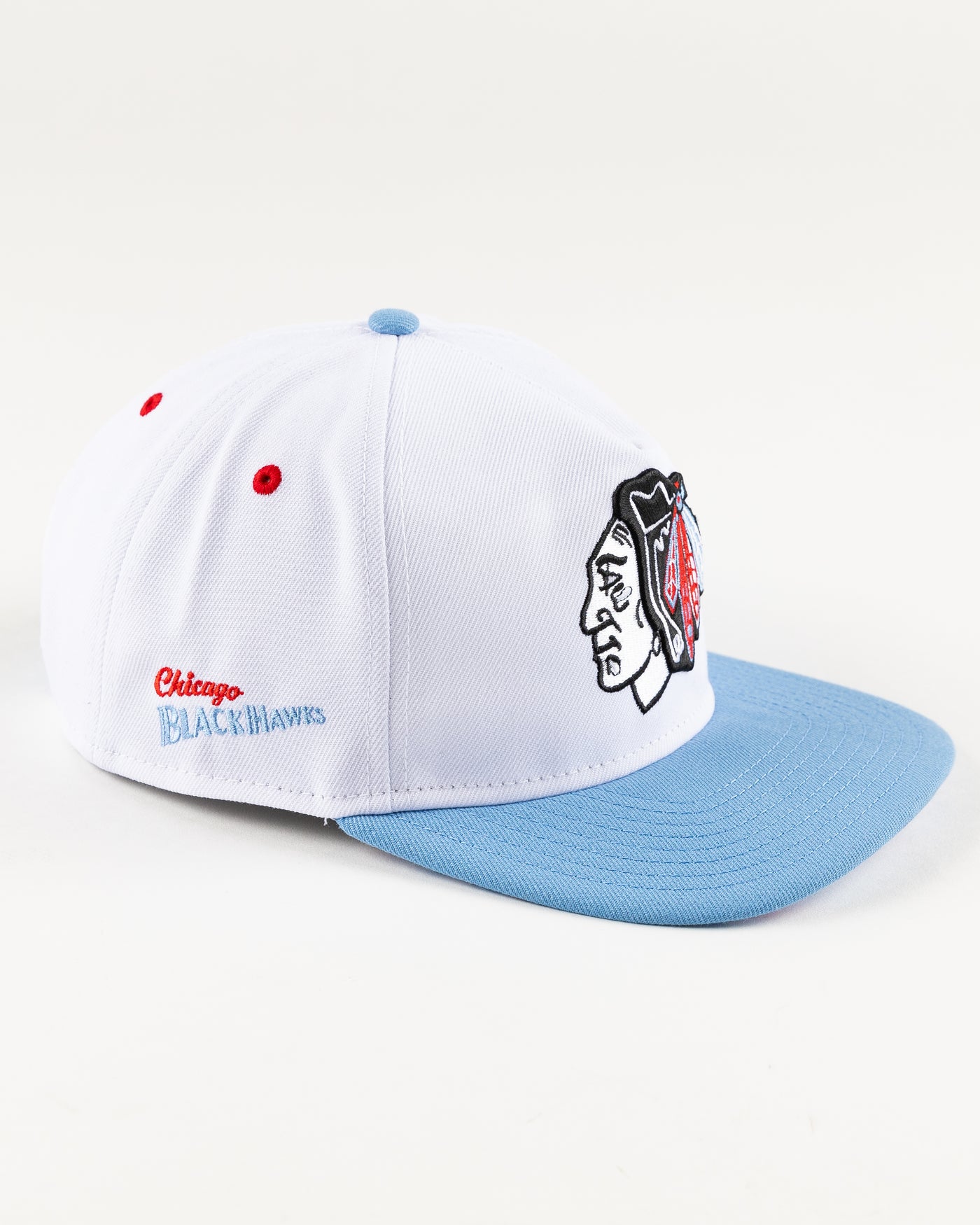white and blue New Era snapback with Chicago Blackhawks primary logo on front - right angle lay flat