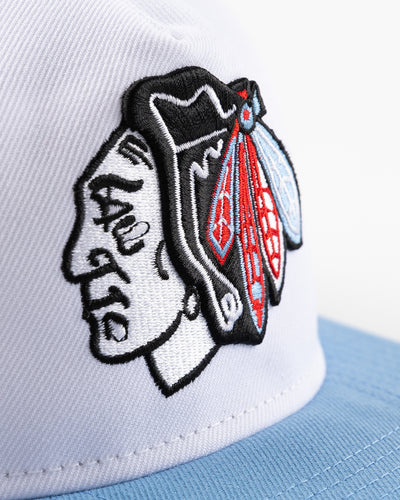 white and blue New Era snapback with Chicago Blackhawks primary logo on front - detail lay flat