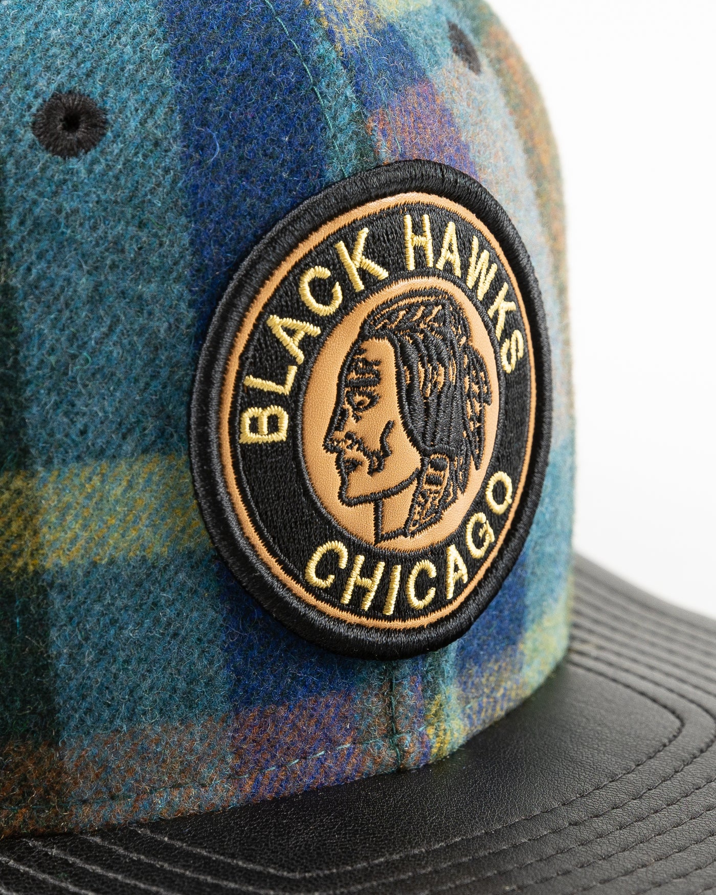 New Era snapback with wool checker crown and vintage Chicago Blackhawks logo and leather flat brim - detail front lay flat