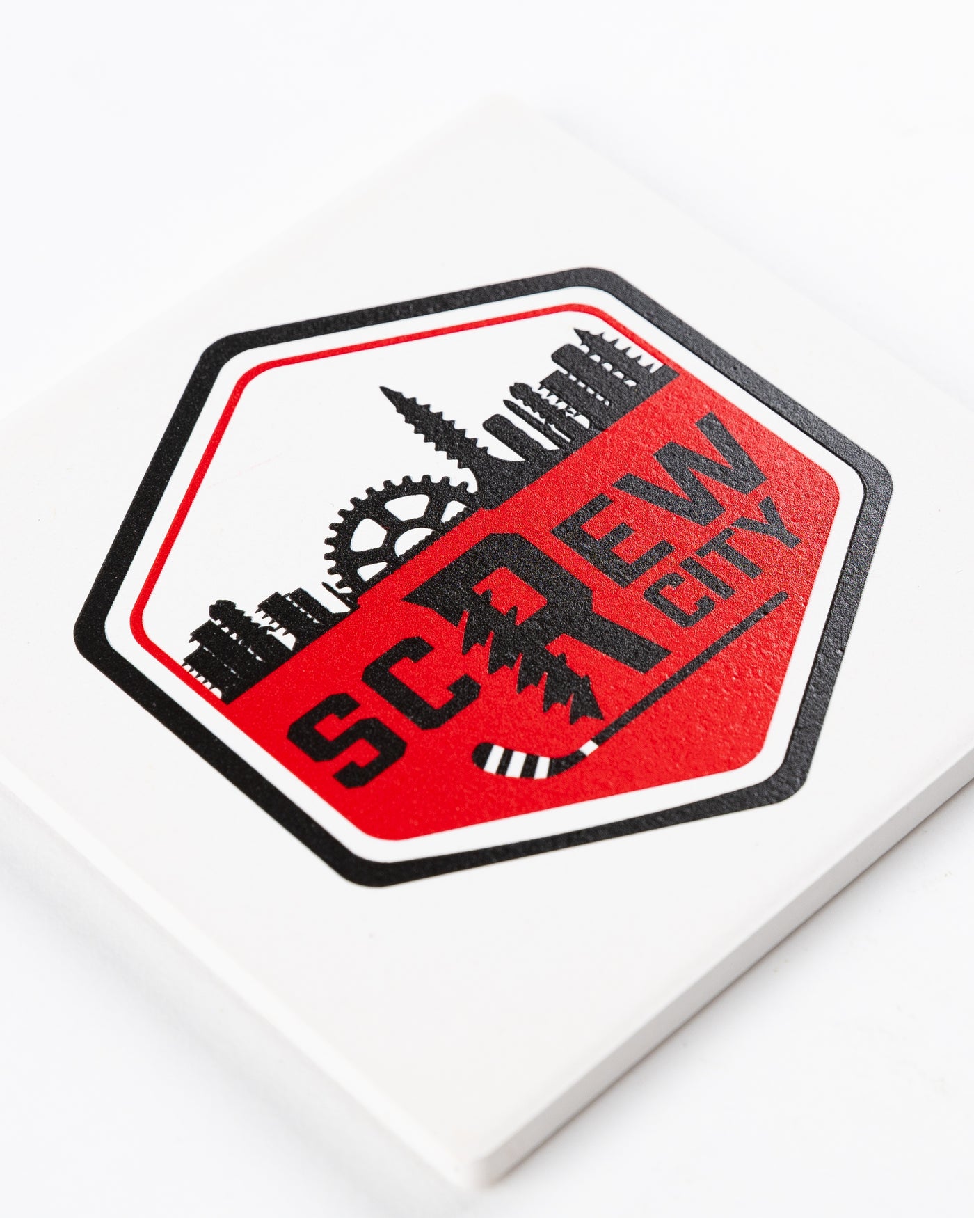white Rockford IceHogs coaster with Screw City logo decal on front - detail lay flat