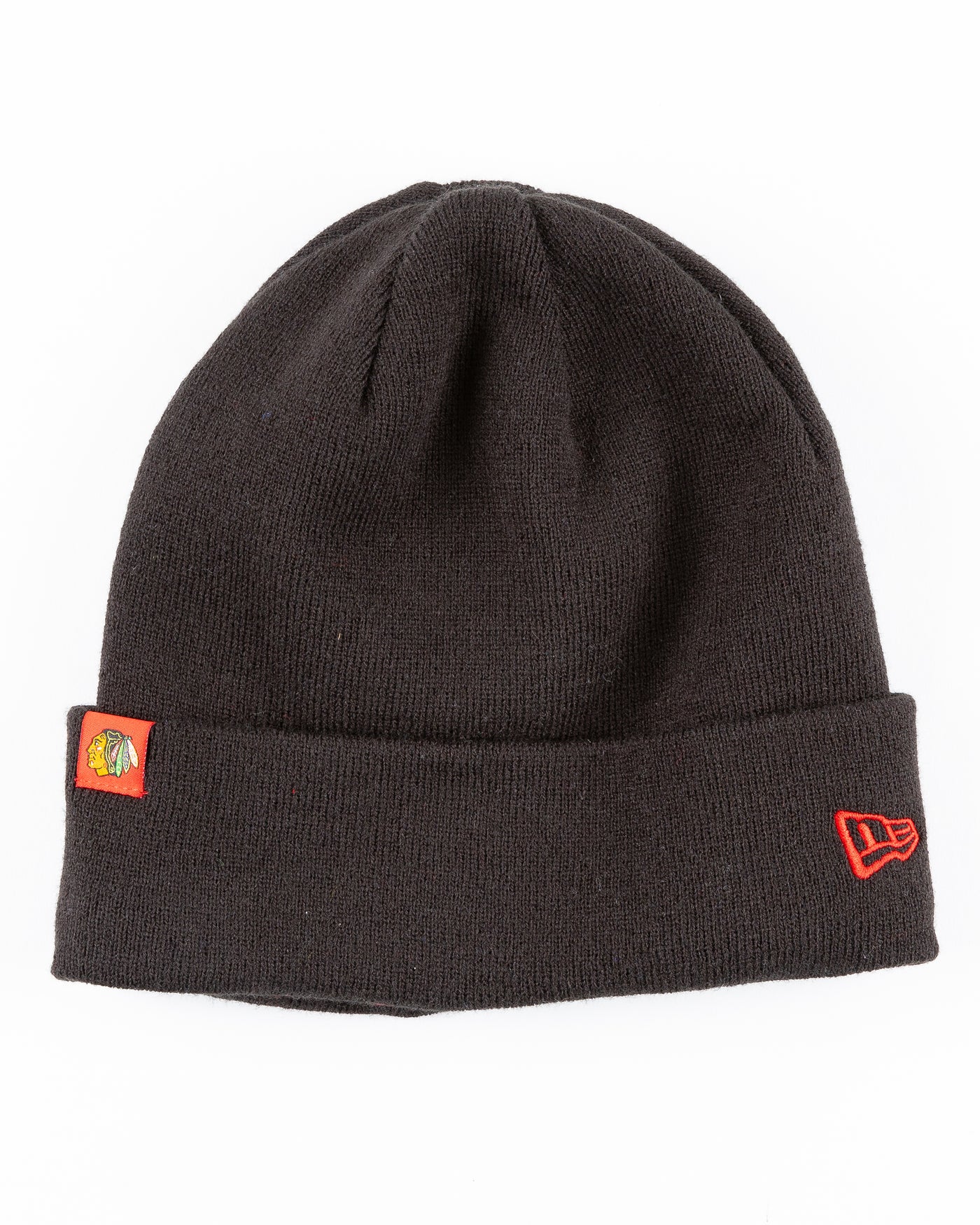 black New Era beanie lined with red satin with Chicago Blackhawks primary logo on tag on front cuff - front lay flat
