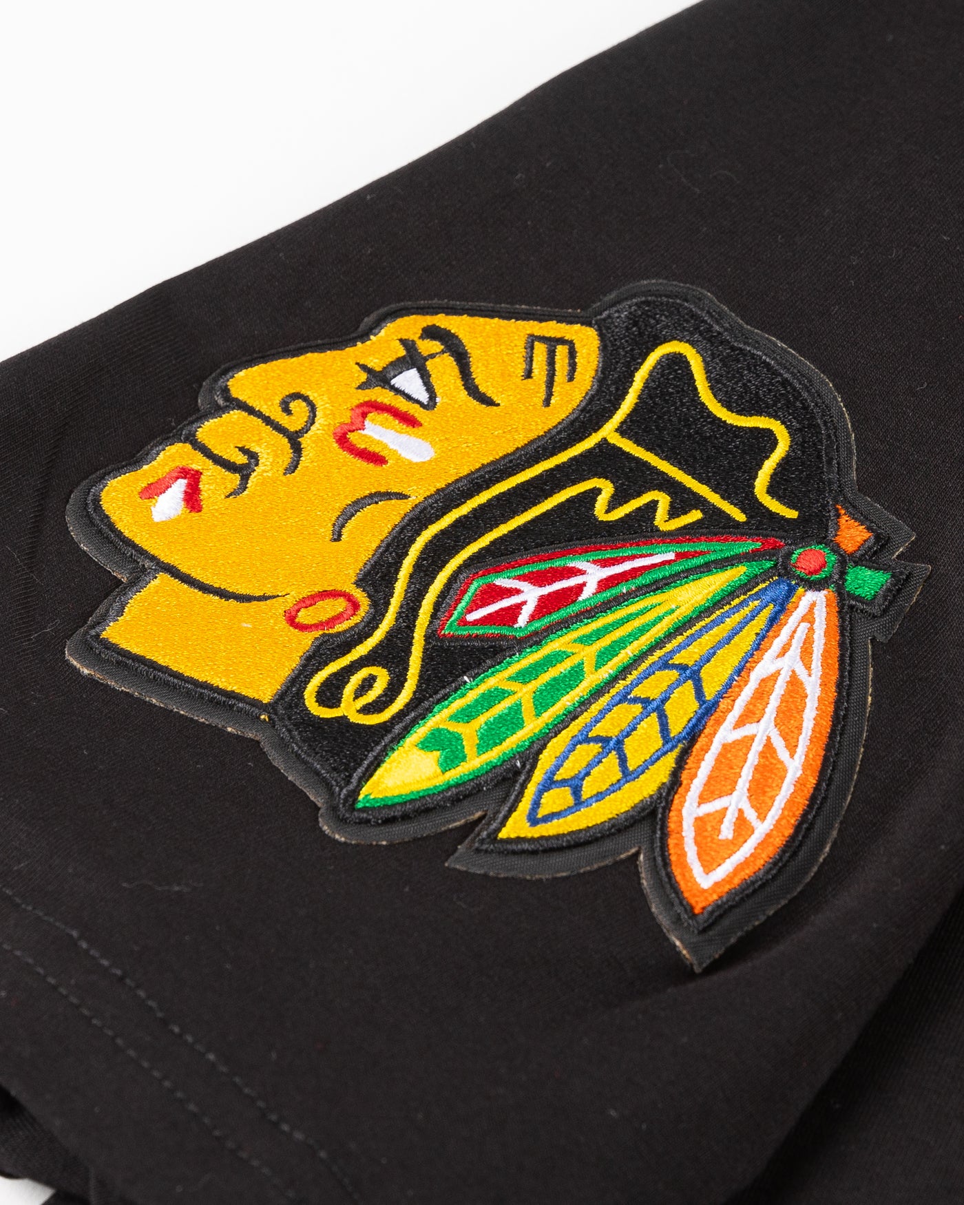 black Pro Standard tee with embroidered Chicago Blackhawks detailing on front and shoulders - left shoulder lay flat