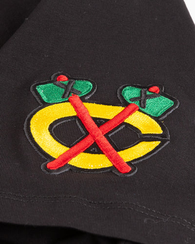 black cropped tee with embroidered Chicago Blackhawks patches on chest, shoulder and back - detail secondary logo lay flat