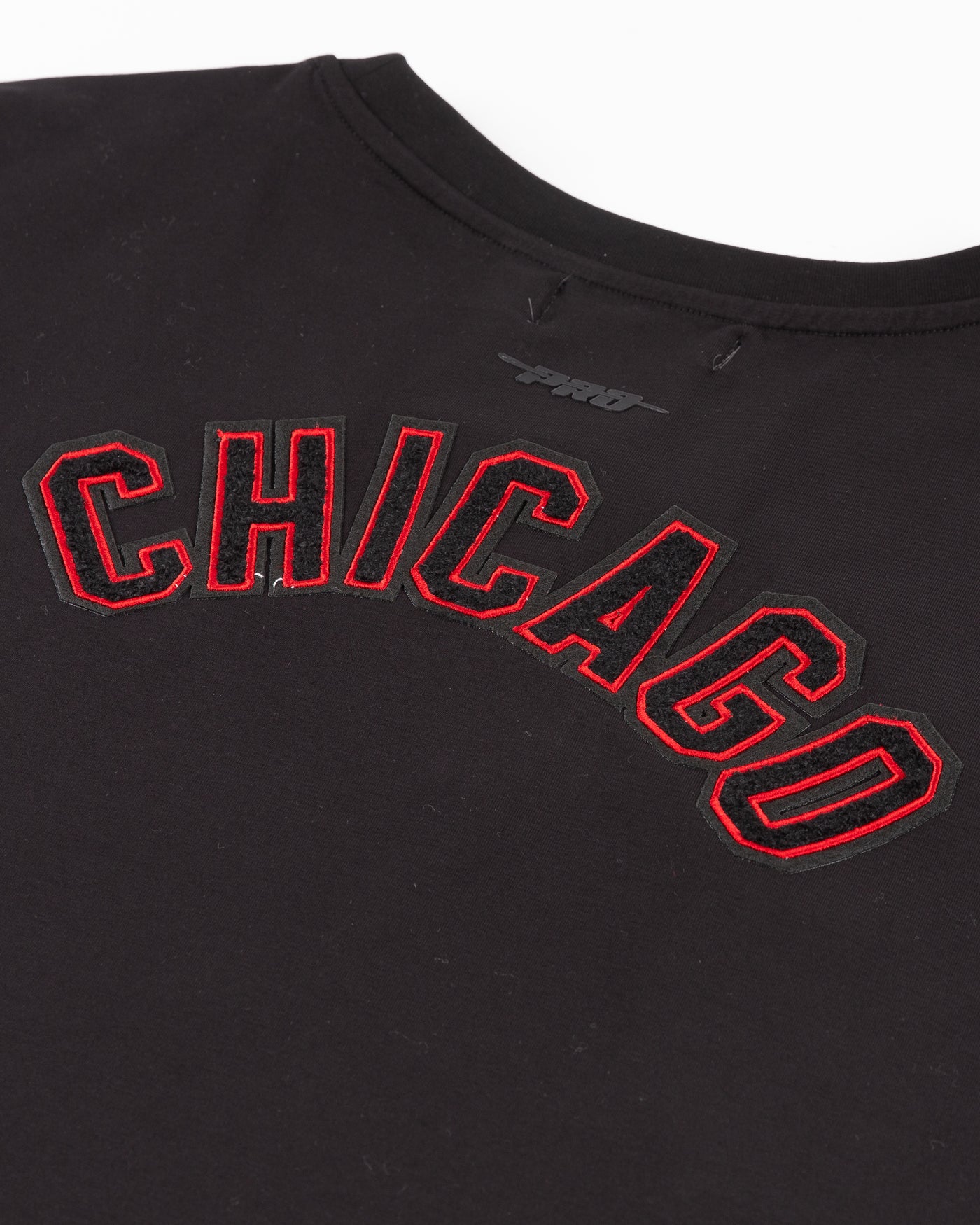 black cropped tee with embroidered Chicago Blackhawks patches on chest, shoulder and back - back lay flat