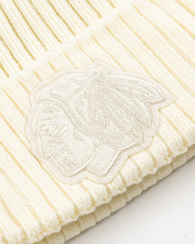 eggshell Pro Standard knit beanie with tonal embroidered Chicago Blackhawks primary logo on front and embroidered tonal wordmark on back - detail front lay flat