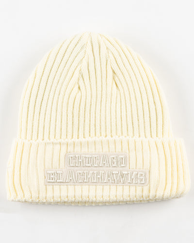 eggshell Pro Standard knit beanie with tonal embroidered Chicago Blackhawks primary logo on front and embroidered tonal wordmark on back - back lay flat