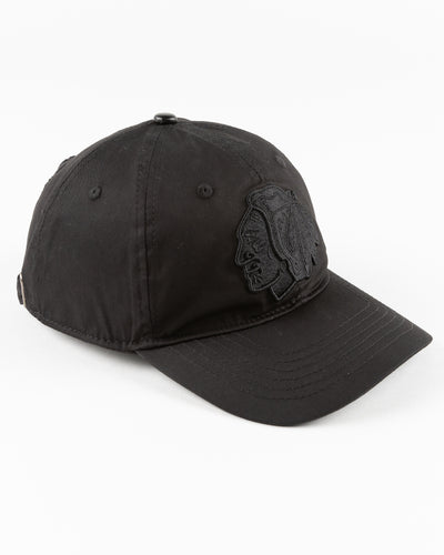 all black adjustable cap with tonal Chicago Blackhawks primary logo embroidered on front - right angle lay flat 