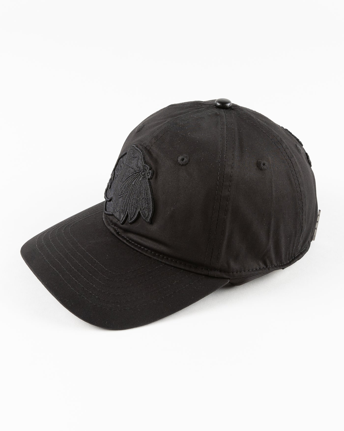 all black adjustable cap with tonal Chicago Blackhawks primary logo embroidered on front - left angle lay flat 