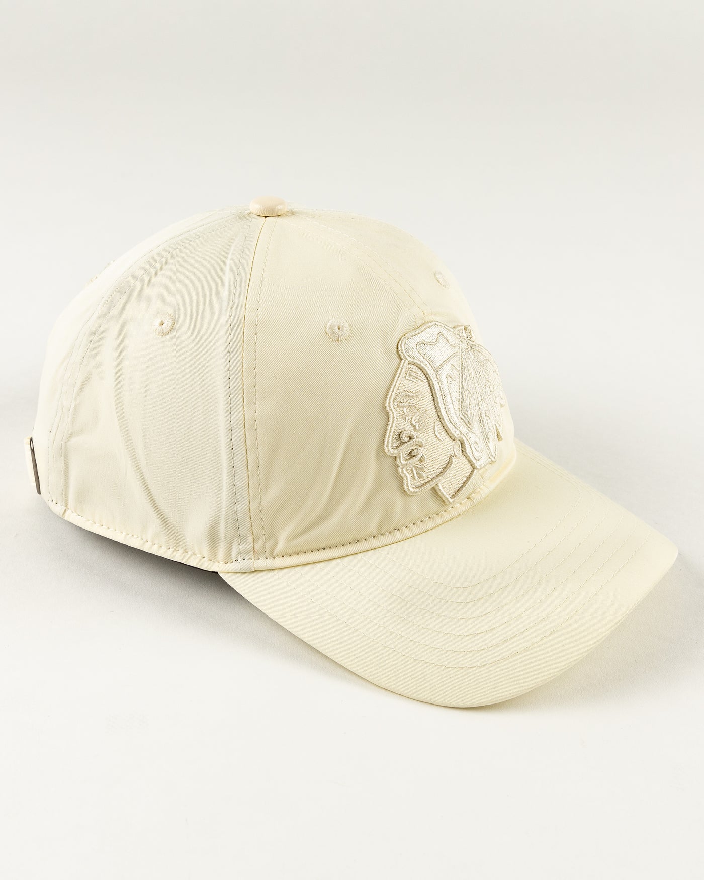 all eggshell adjustable cap with tonal Chicago Blackhawks primary logo embroidered on front - right angle lay flat 