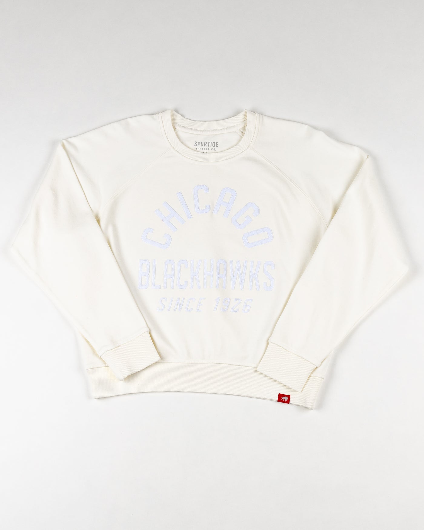 white Sportiqe ladies crewneck with tonal Chicago Blackhawks wordmark graphic embroidered across front - front lay flat