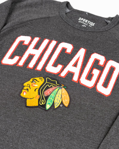 black Sportiqe crewneck with Chicago Blackhawks primary logo and Chicago wordmark embroidered in chenille - detail lay flat