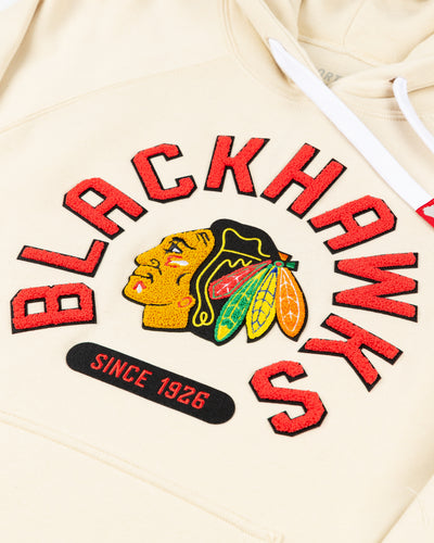 cream Sportiqe hoodie with Chicago Blackhawks primary logo and wordmark in chenille across front - detail lay flat