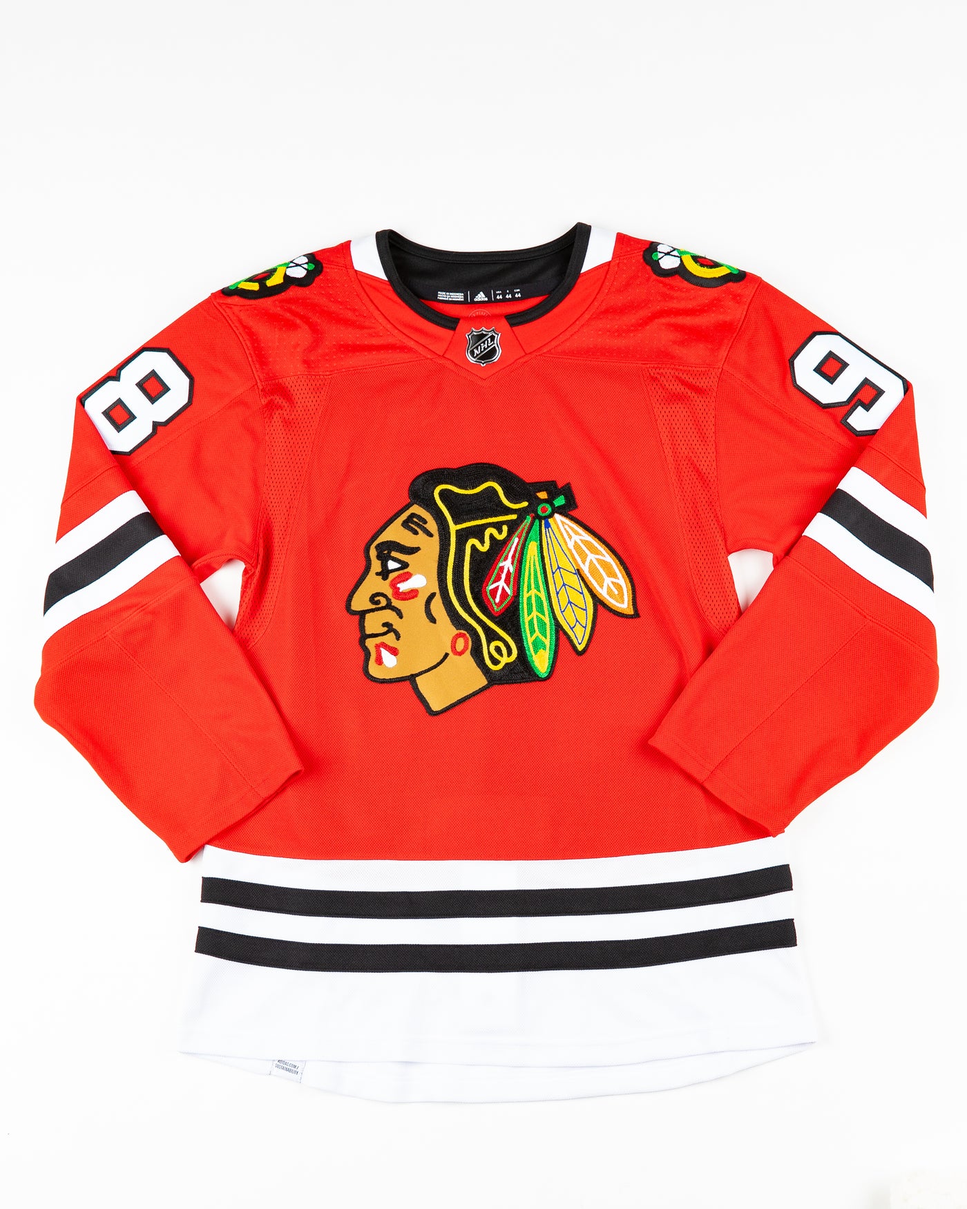 adidas red home Chicago Blackhawks hockey jersey with Connor Bedard name and number - front lay flat