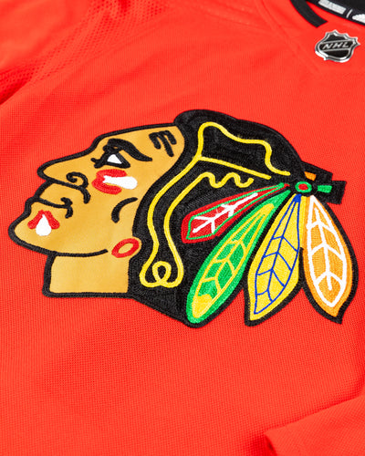 adidas red home Chicago Blackhawks hockey jersey with Connor Bedard name and number - front detail lay flat