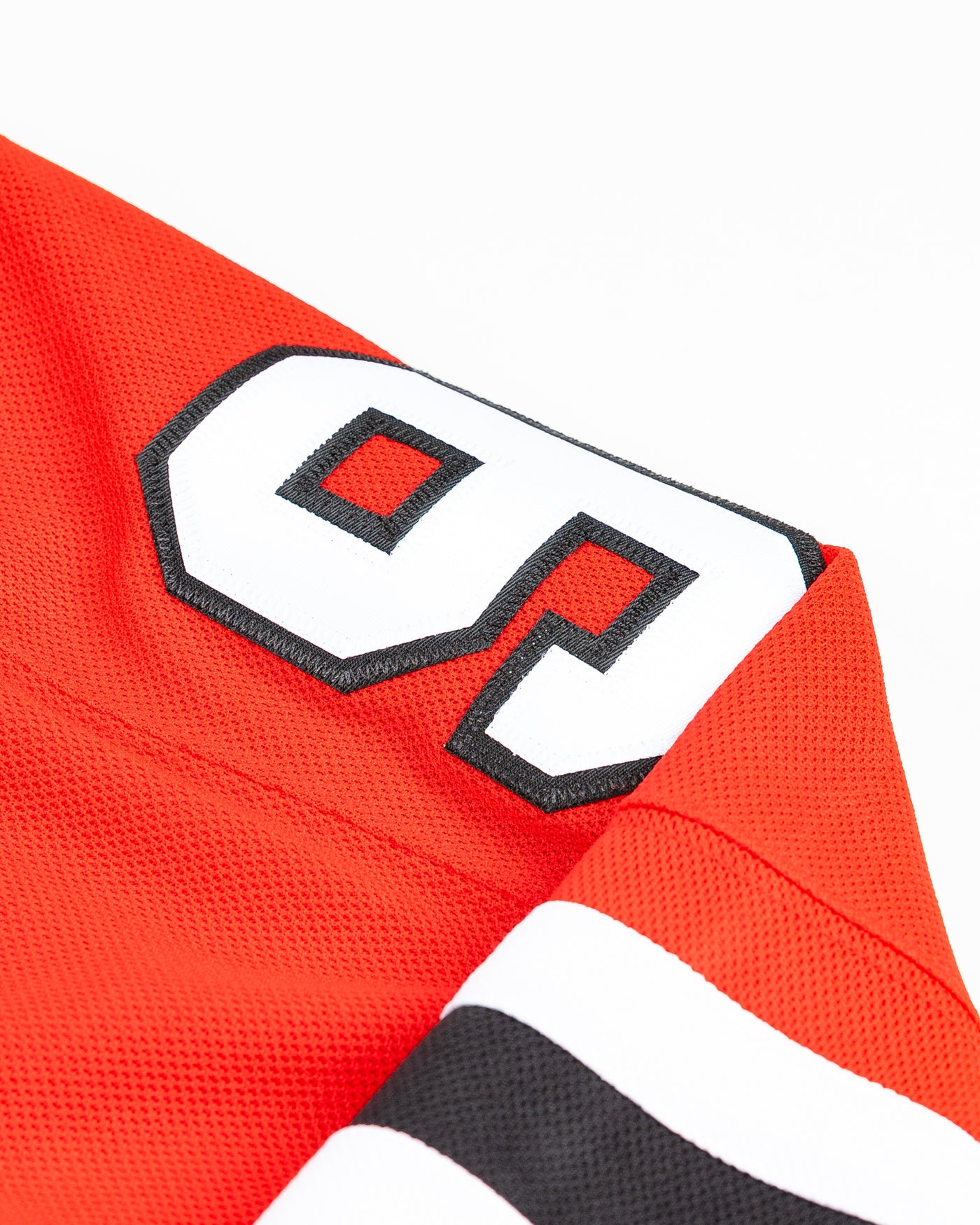 adidas red home Chicago Blackhawks hockey jersey with Connor Bedard name and number - arm detail lay flat