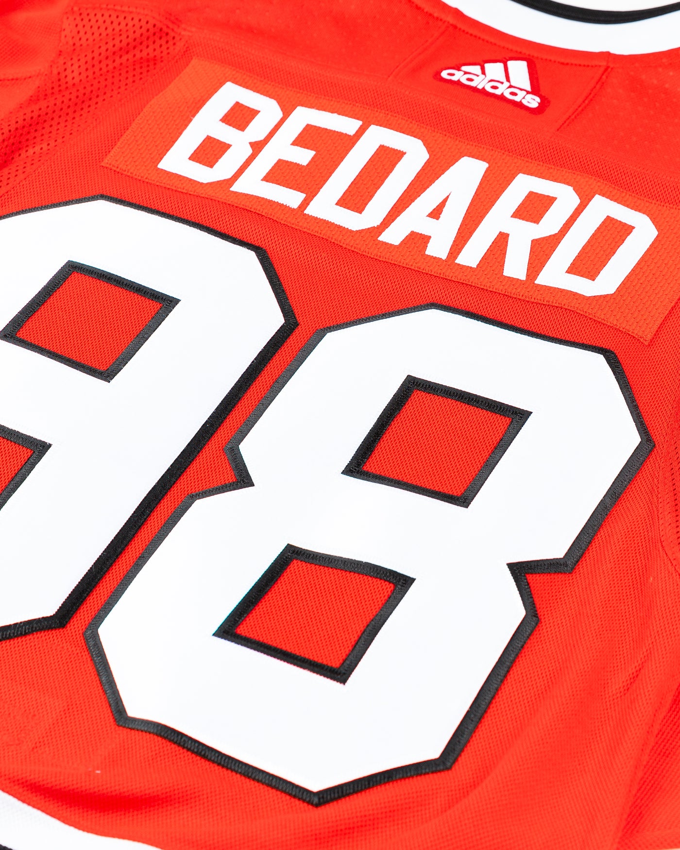 adidas red home Chicago Blackhawks hockey jersey with Connor Bedard name and number - back detail lay flat