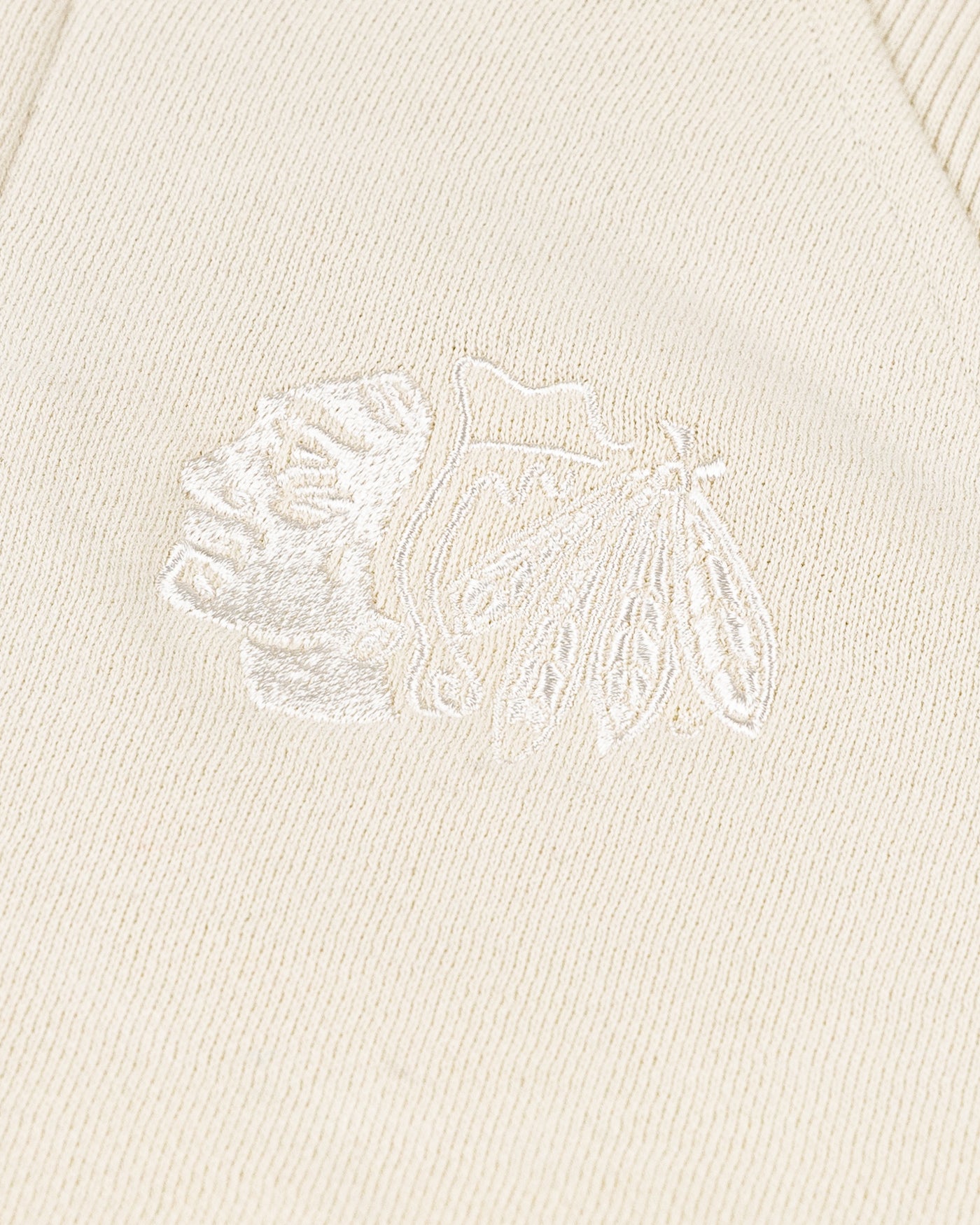 cream colored lululemon cropped ladies half zip with tonal Chicago Blackhawks primary logo embroidered on left chest - detail lay flat