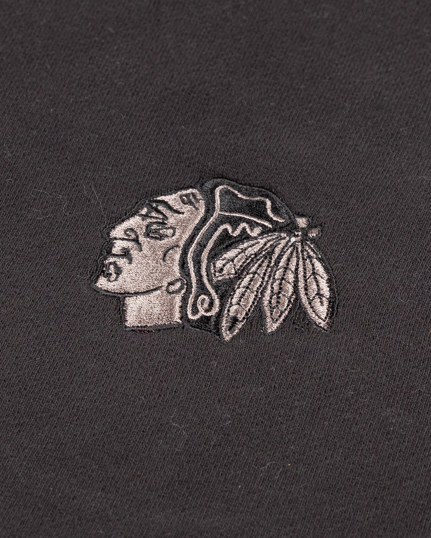 black lululemon half zip with tonal Chicago Blackhawks primary logo embroidered on left chest - detail lay flat 