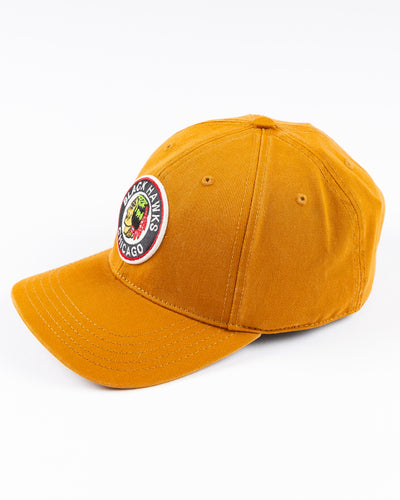 brown American Needle snapback cap with vintage Chicago Blackhawks logo embroidered on front - left angle lay flat