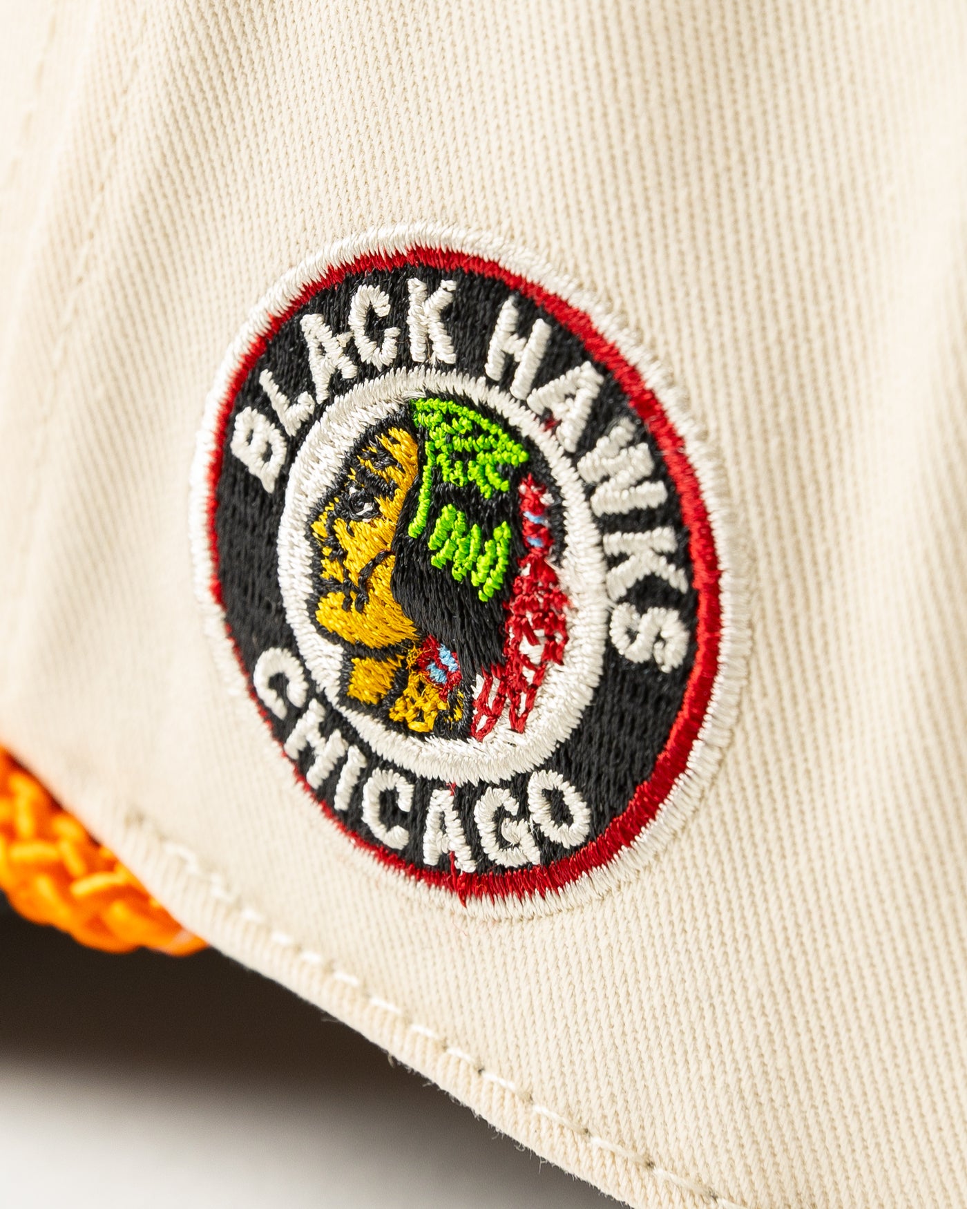 beige, black and orange snapback rope hat with Original Six hockey word graphic across front and vintage Chicago Blackhawks logo embroidered on left side - side detail lay flat
