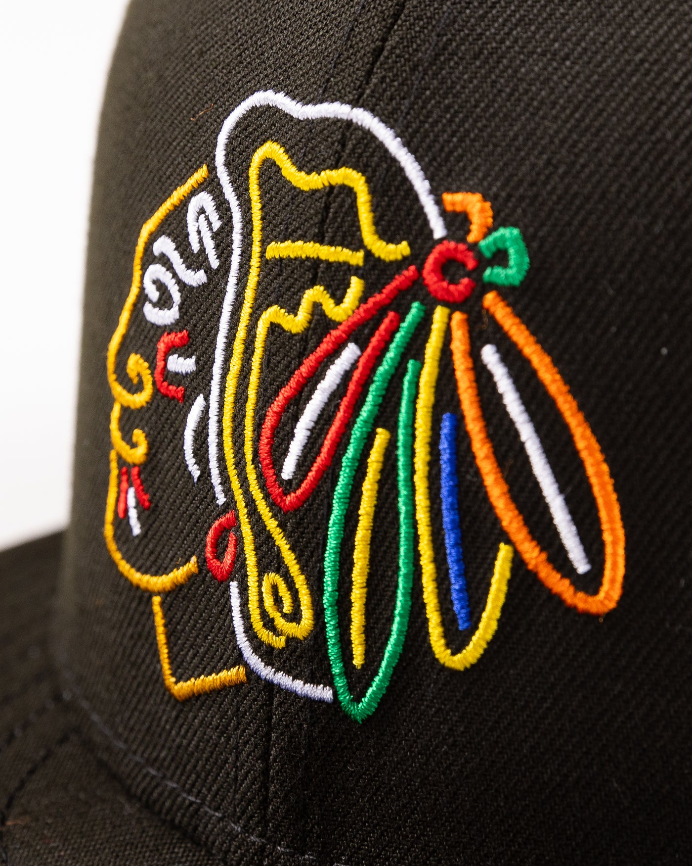 black New Era fitted cap with Chicago Blackhaks primary logo embroidered in front and secondary logo embroidered on back in neon lights colorway - detail front lay flat