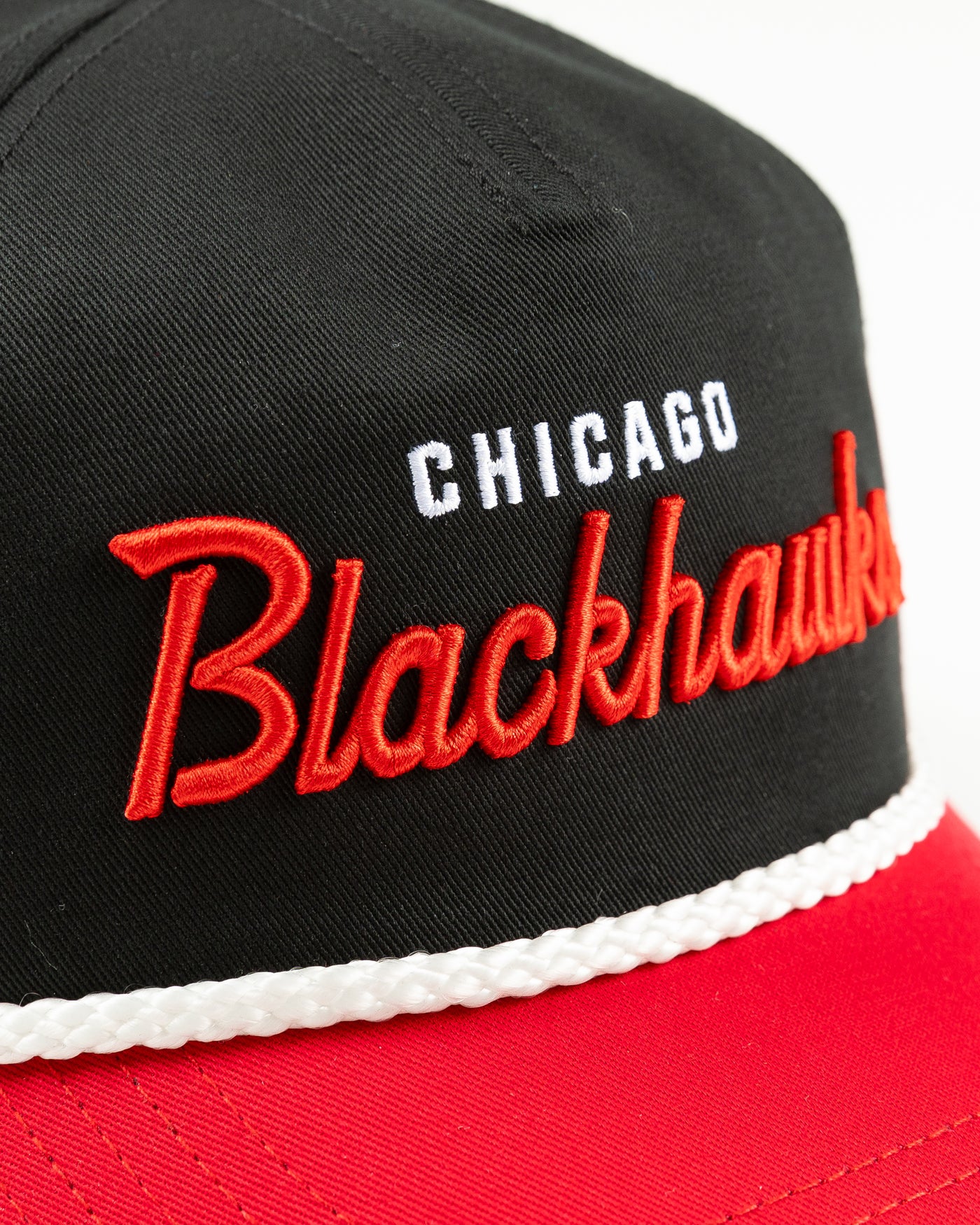 black and red rope snapback with Chicago Blackhawks wordmark across front and primary logo on left side - detail front lay flat