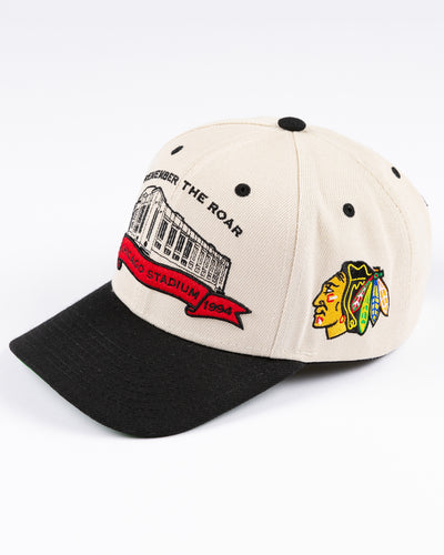 beige Mitchell & Ness snapback cap with Chicago Stadium embroidered design and Chicago Blackhawks primary logo on left side - left angle lay flat