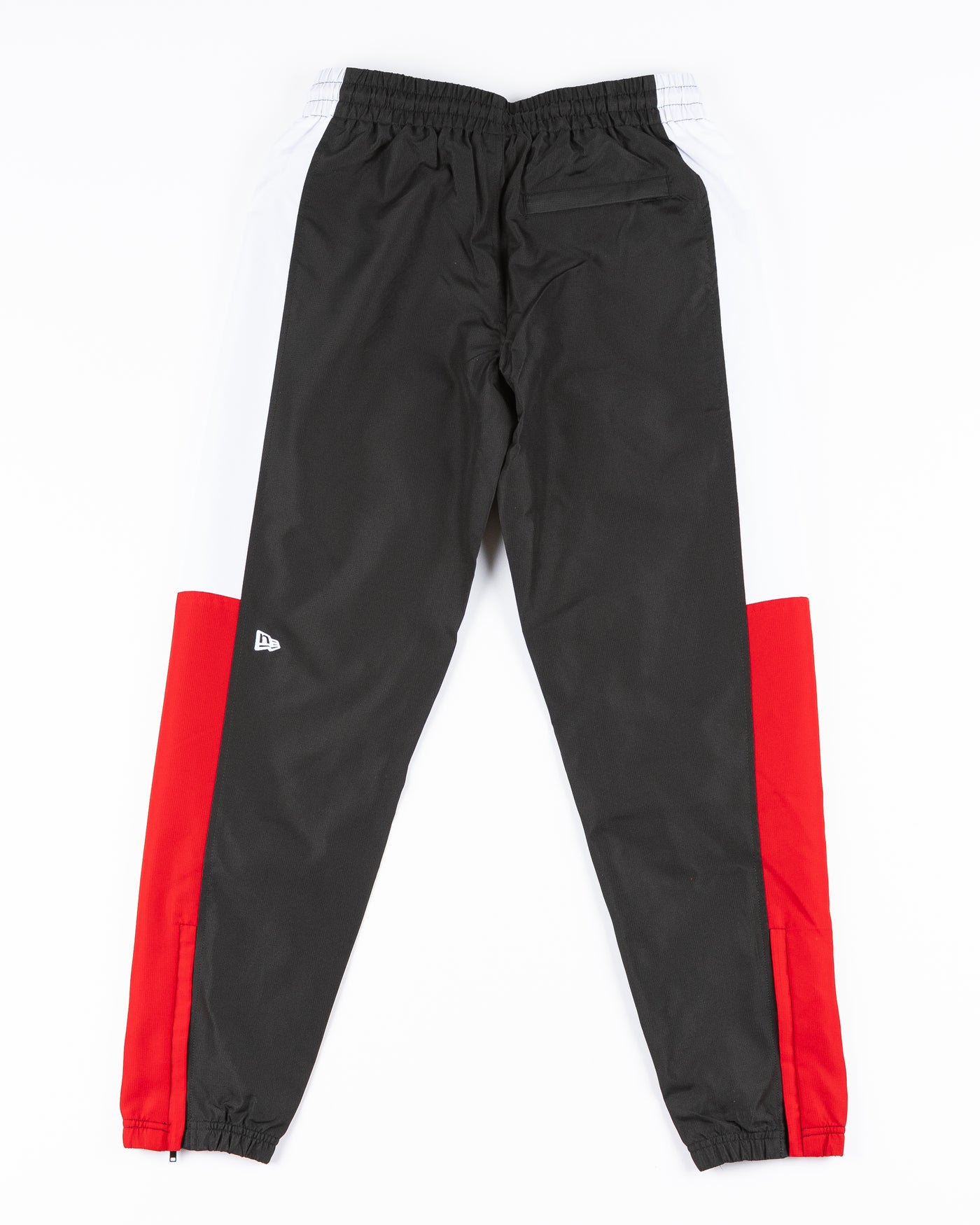 black red and white color blocked track pants with Chicago Blackhawks primary logo and wordmark on left leg - back lay flat