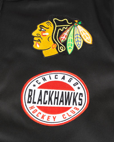 black red and white New Era track jacket with Chicago Blackhawks patches on front - front detail lay flat