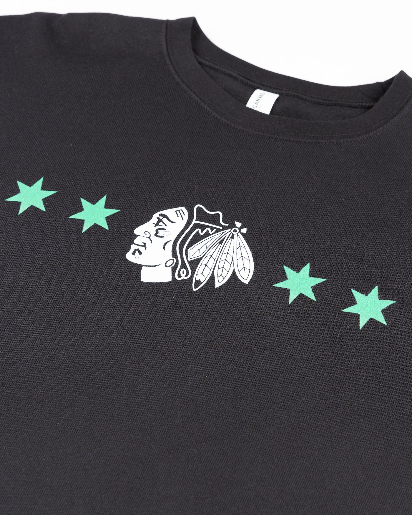 black crewneck with Chicago Blackhawks primary logo and four stars inspired design for St. Patrick's Day - detail lay flat