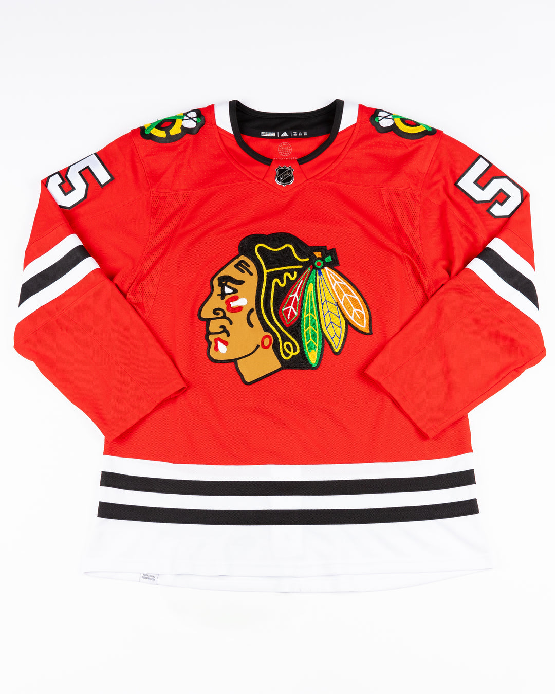 red adidas Chicago Blackhawks jersey with Kevin Korchinski name and number stitched - front lay flat