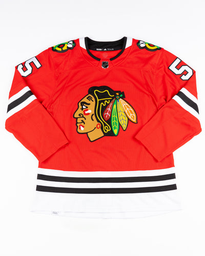red adidas Chicago Blackhawks jersey with Kevin Korchinski name and number stitched - front lay flat