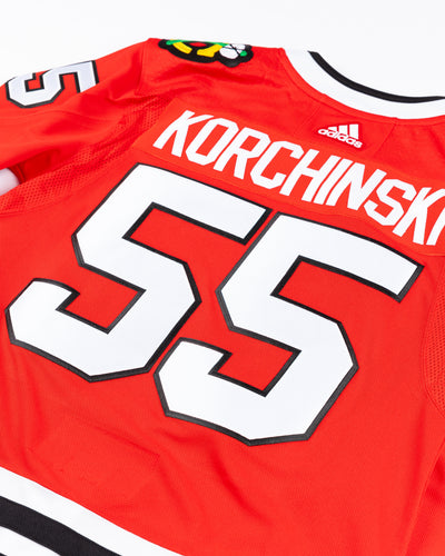 red adidas Chicago Blackhawks jersey with Kevin Korchinski name and number stitched - back detail lay flat