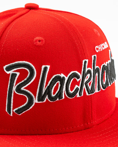 red youth New Era snapback cap with Chicago Blackhawks embroidered wordmark and primary logo on right side - front detail lay flat