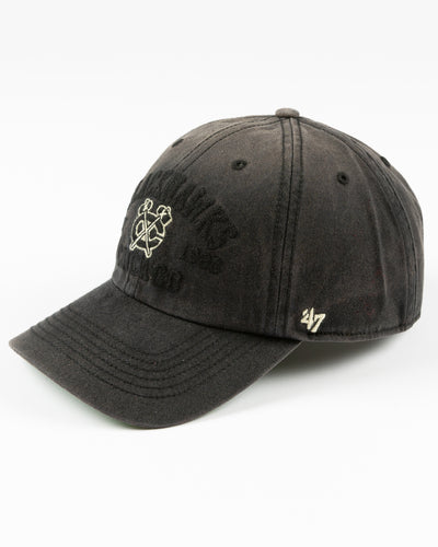 '47 brand washed black adjustable cap with Chicago Blackhawks wordmark and secondary logo embroidered on front - left angle lay flat