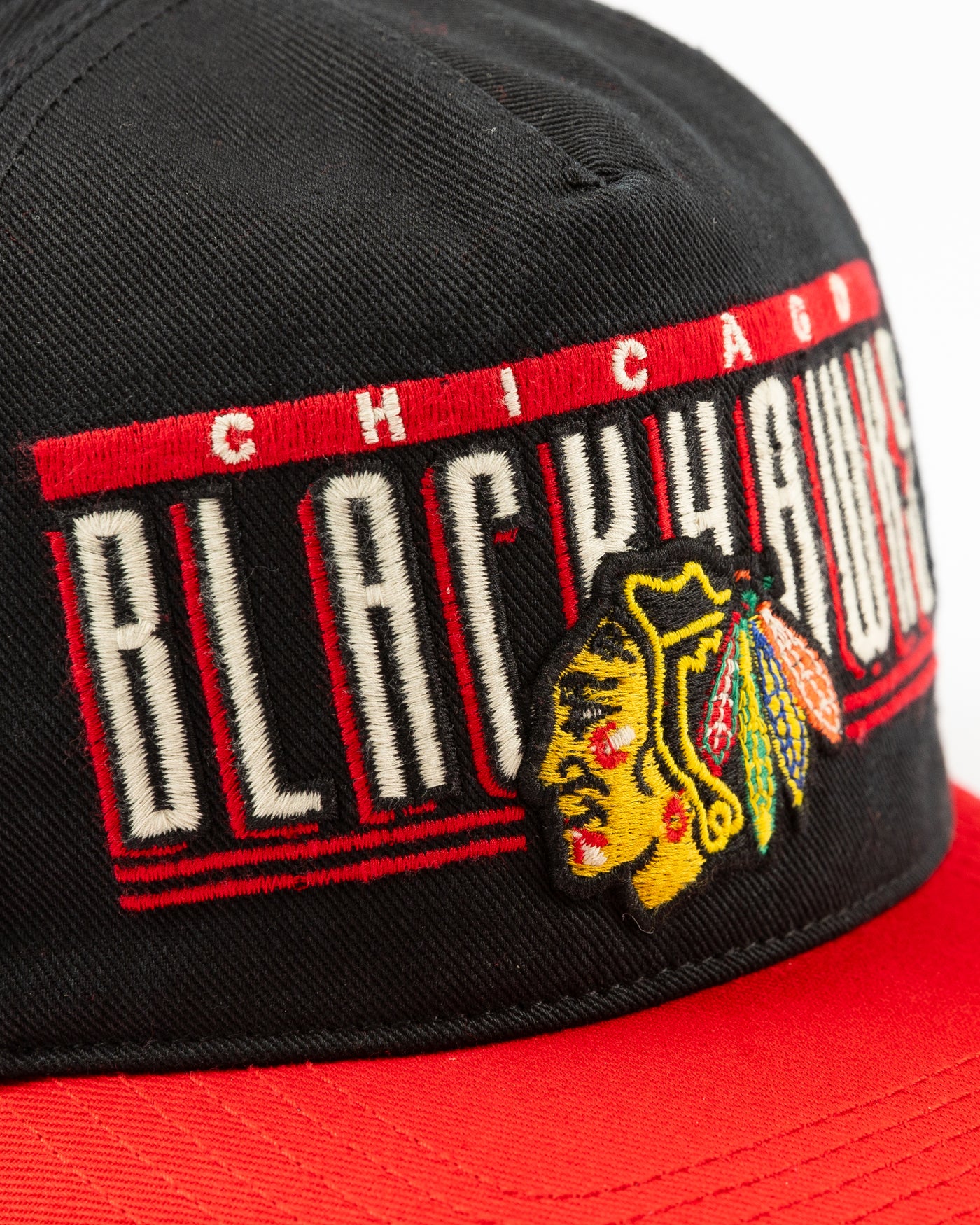 black and red '47 brand snapback hat with Chicago Blackhawks wordmark and primary logo embroidered on the front - detail lay flat
