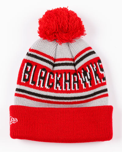 New Era knit hat with pom with Chicago Blackhawks wordmark across front and embroidered primary logo on cuff - back lay flat