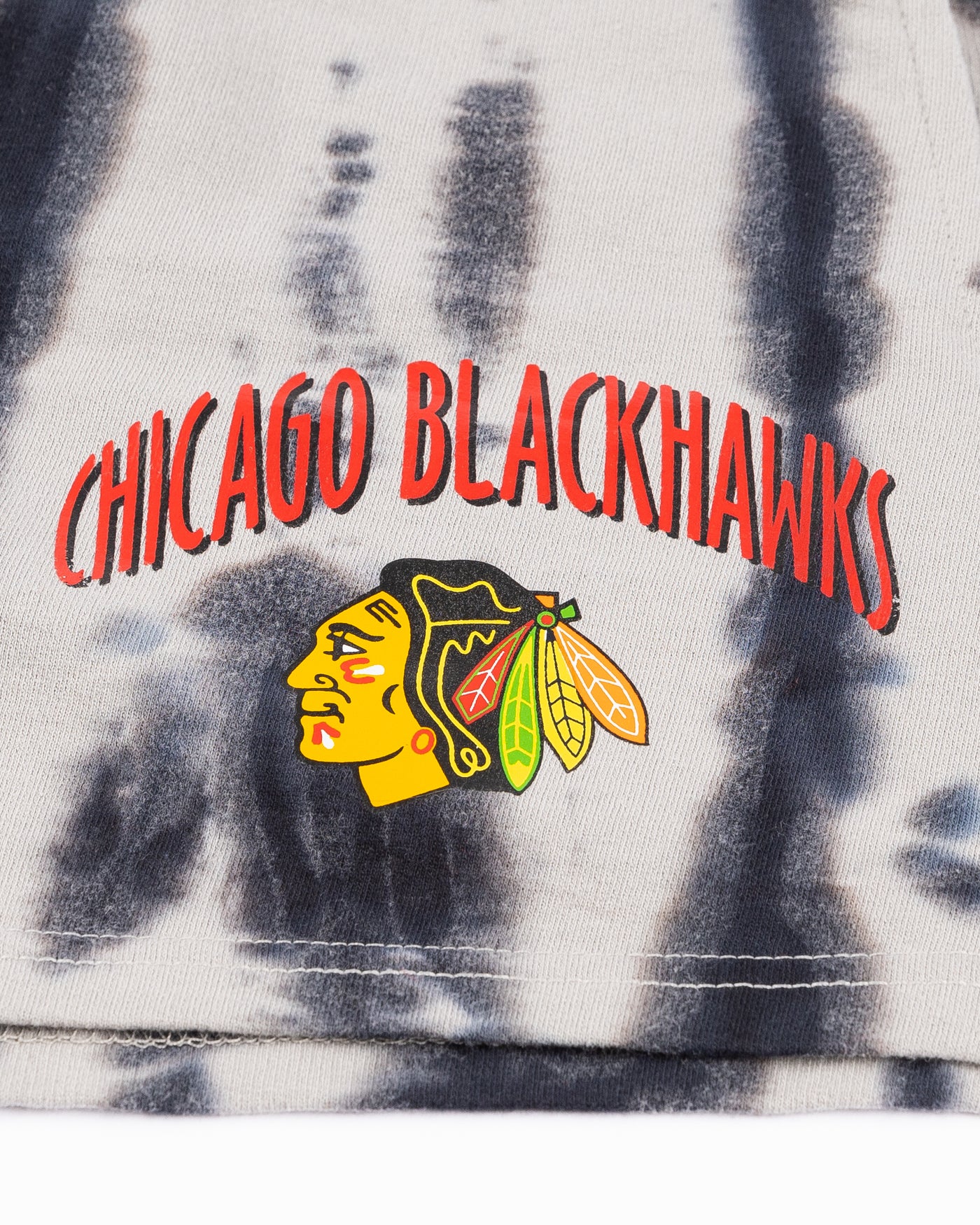 youth girl shorts with all over distressed print and Chicago Blackhawks wordmark and primary logo printed on left leg - detail lay flat