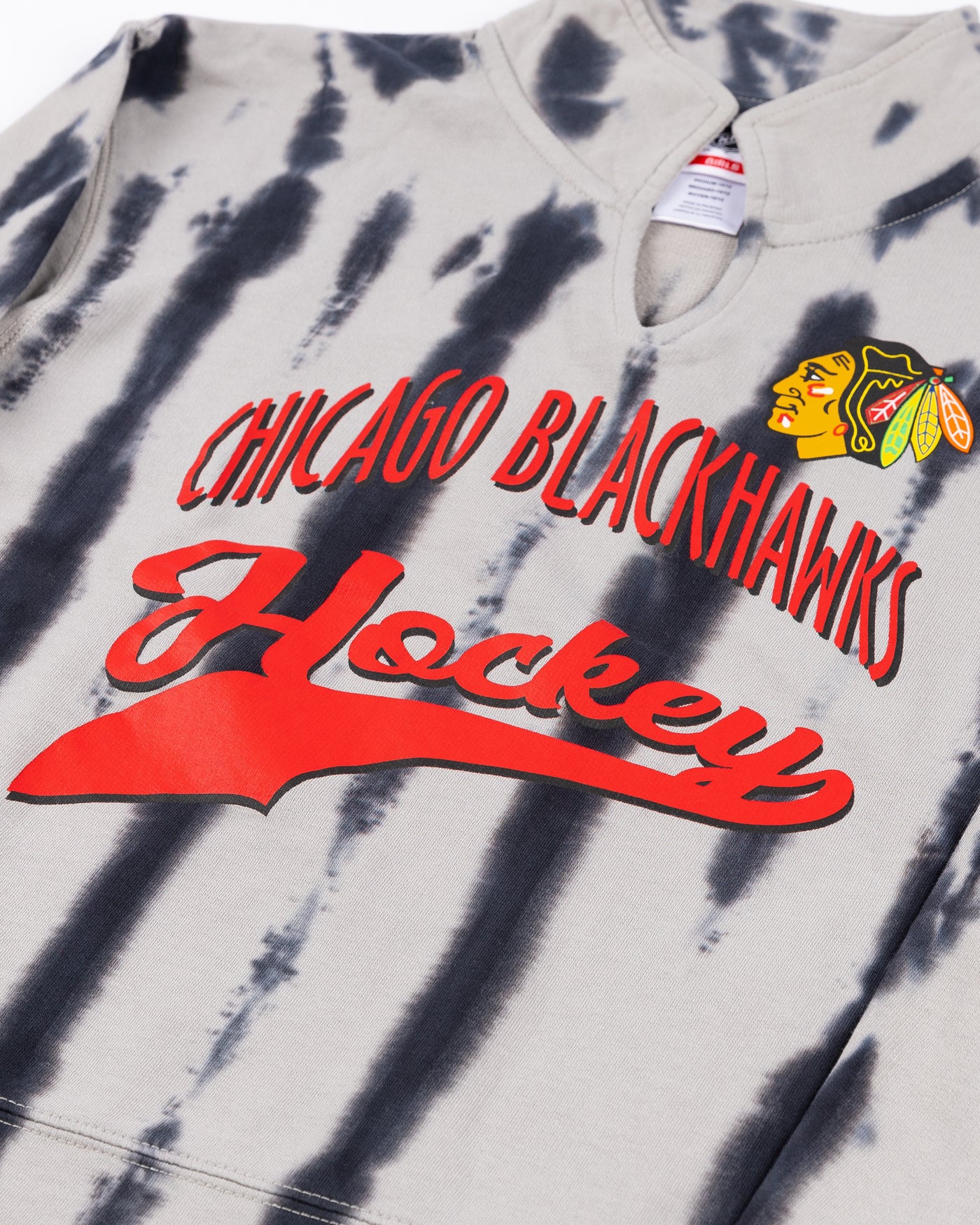 youth girl pullover with distressed all over print and Chicago Blackhawks wordmark and primary logo on front - detail lay flat 