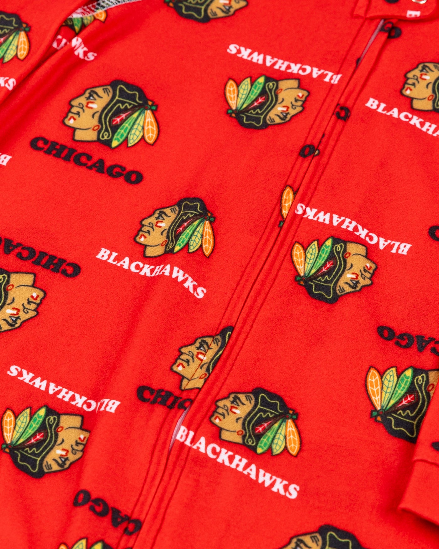 Chicago Blackhawks newborn onesie with all over primary logo print - detail lay flat