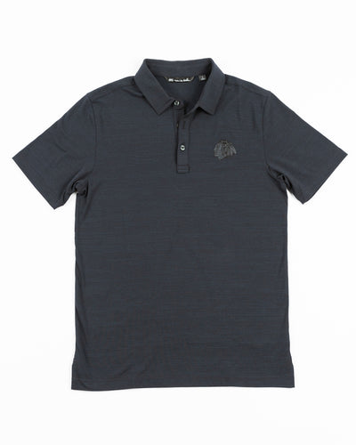 black TravisMathew polo with Chicago Blackhawks tonal primary logo embroidered on left chest - front lay flat