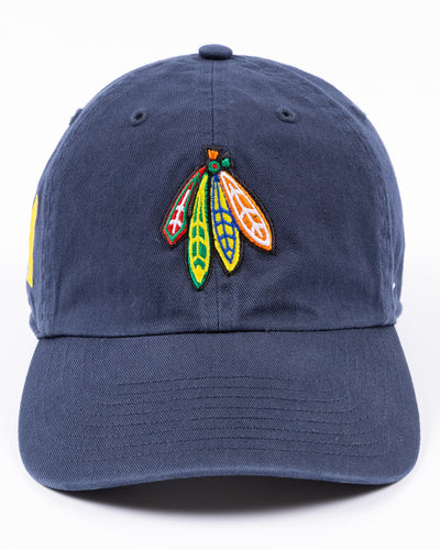 navy '47 brand adjustable hat with Chicago Blackhawks four feather logo embroidered on front and University of Michigan logo embroidered on right side - front lay flat