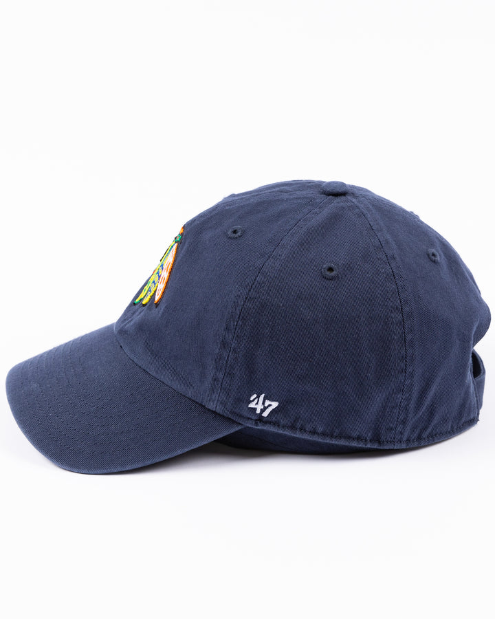 navy '47 brand adjustable hat with Chicago Blackhawks four feather logo embroidered on front and University of Michigan logo embroidered on right side - left side lay flat