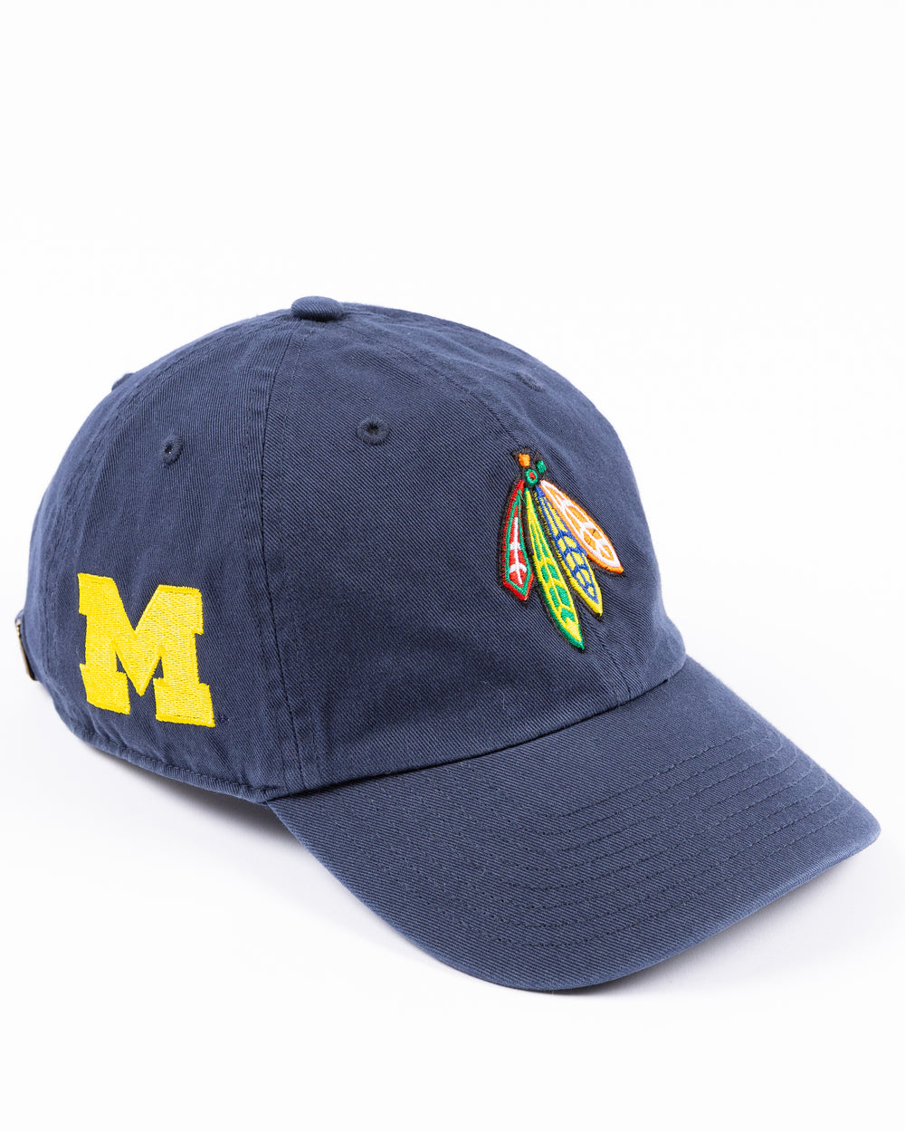 navy '47 brand adjustable hat with Chicago Blackhawks four feather logo embroidered on front and University of Michigan logo embroidered on right side - right angle lay flat